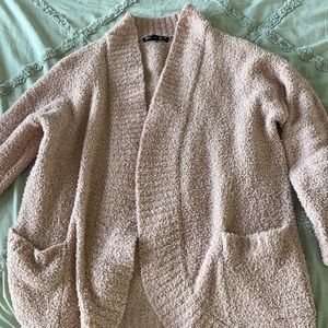 Pink fuzzy cardigan sweater.